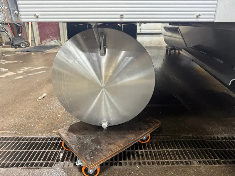 Slide: The Image of An aluminum pontoon on a wheeled cart in a workshop setting. - 36