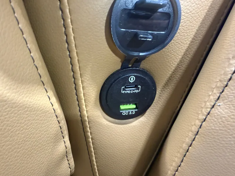 Slide: The Image of Close-up of a USB-C port in a beige leather seat. - 24