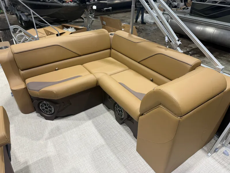 Slide: The Image of Brown, cushioned L-shaped bench seating on a boat, with speakers underneath. - 29
