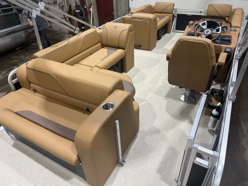 Slide: The Image of Interior of a 2027 Tahoe Sport 1980 Cruise with beige leather seating and a modern helm station. - 19