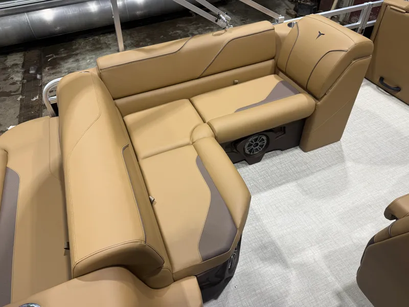 Slide: The Image of The image shows a luxurious, beige upholstered bench seat on a boat. - 16