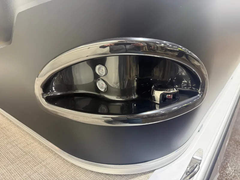 Slide: The Image of Close-up of a shiny, oval boat detail with two lights and a switch. - 32