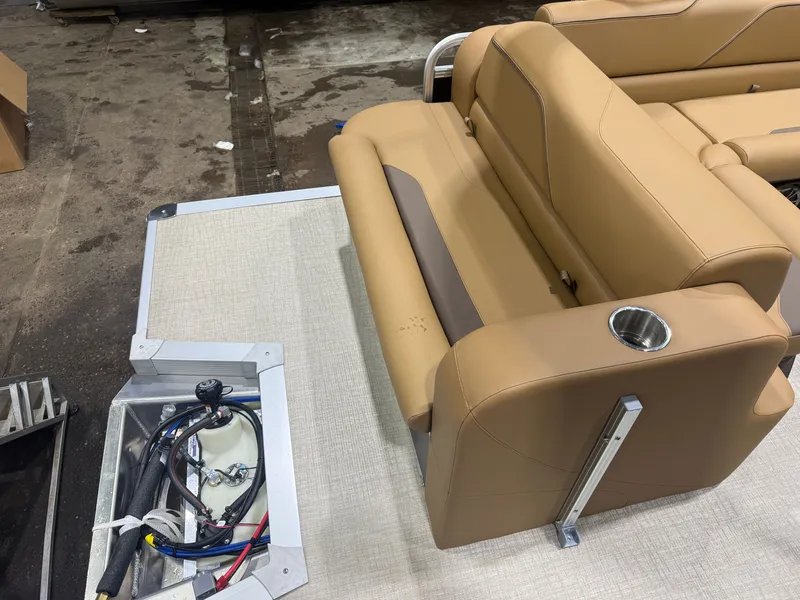 Slide: The Image of The image shows a beige rear bench seat on a boat with a cup holder and cables nearby. - 17