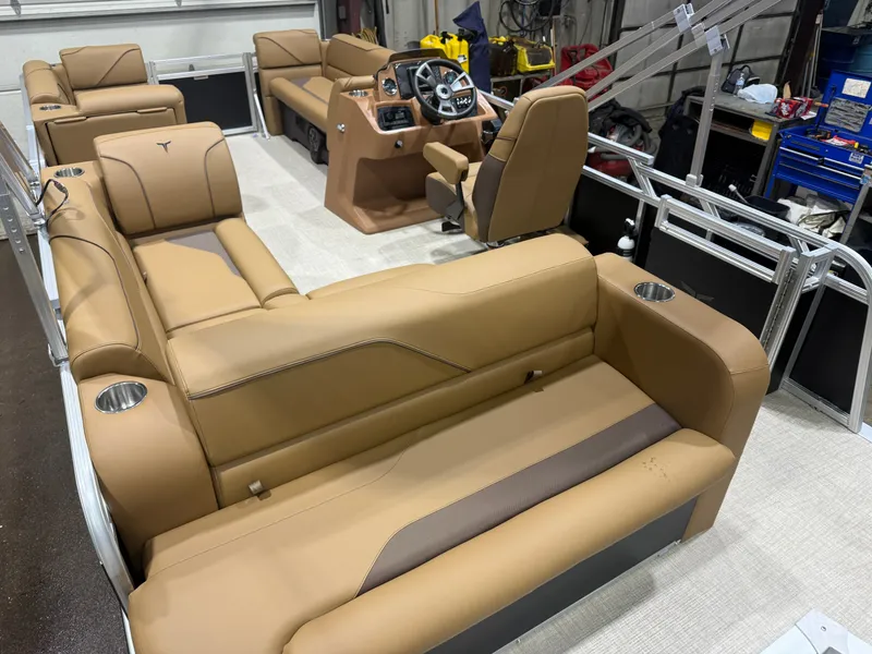 Slide: The Image of Interior view of a modern pontoon boat with beige leather seating and a central helm station. - 18