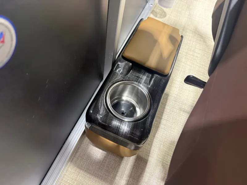 Slide: The Image of Close-up of a cup holder on a boat with cushioned seat and metal surface. - 15