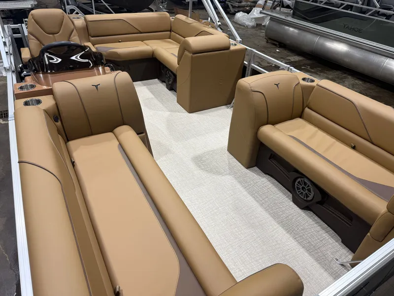 Slide: The Image of Interior of a 2027 Tahoe Sport 1980 Cruise with brown leather seating and a modern helm. - 27