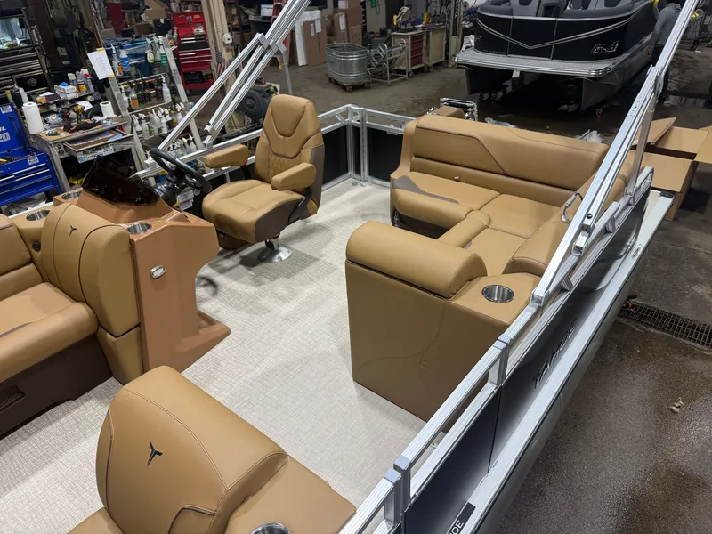 Slide: The Image of Interior view of a modern pontoon boat with beige leather seating and a helm station. - 3