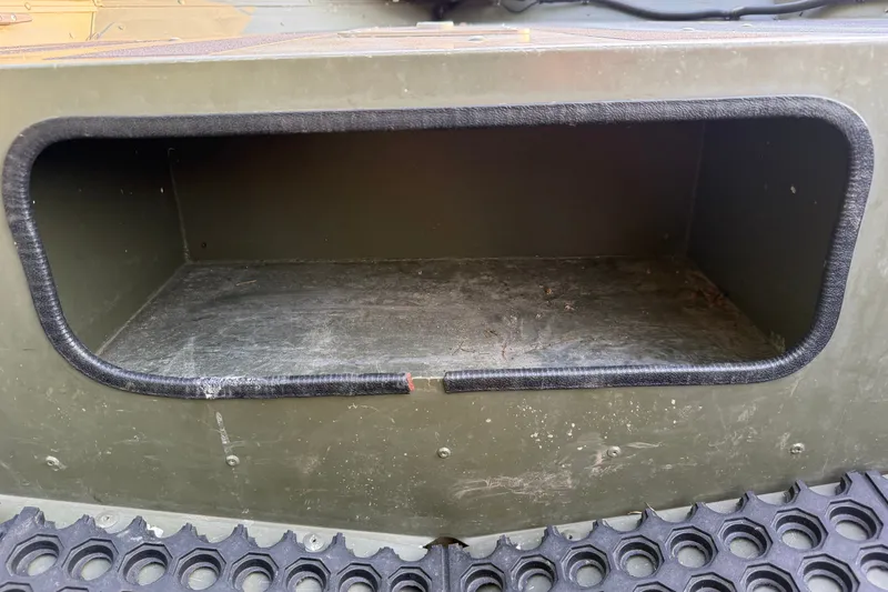 Slide: The Image of Storage compartment of a 2017 Alumacraft MV 1648 Jon boat, featuring a rugged interior. - 12