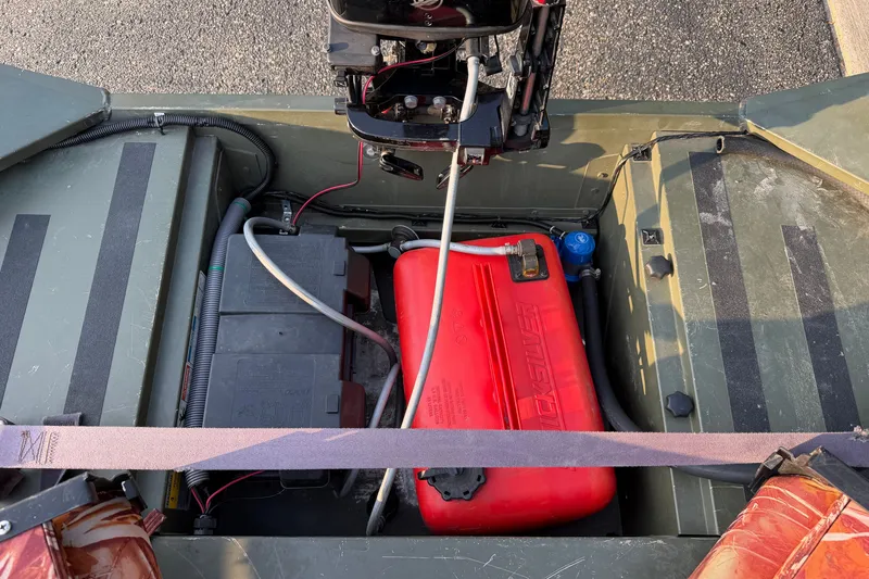 Slide: The Image of 2017 Alumacraft MV 1648 Jon boat interior showing engine, battery, and fuel tank. - 10