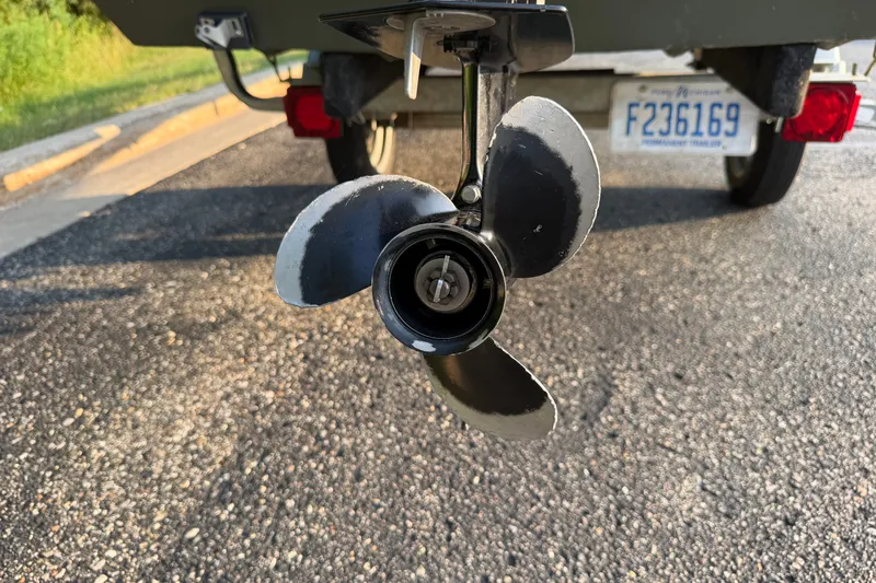 Slide: The Image of 2017 Alumacraft MV 1648 Jon boat propeller close-up on a trailer. - 17