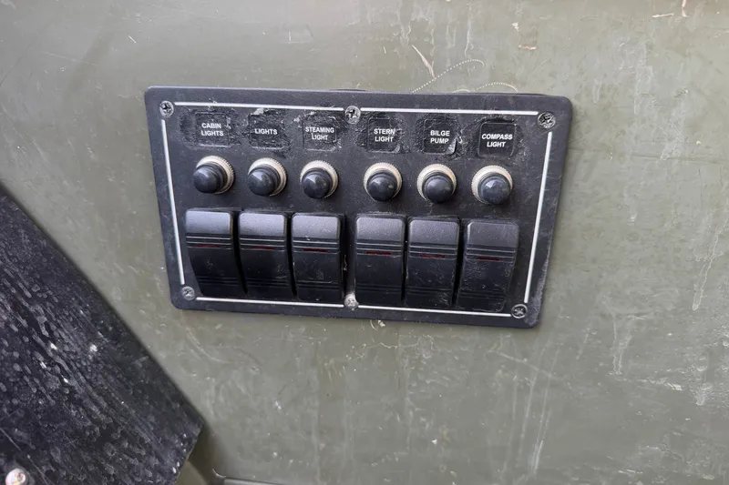 Slide: The Image of Control panel of a 2017 Alumacraft MV 1648 Jon boat with labeled switches. - 15