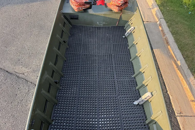 Slide: The Image of 2017 Alumacraft MV 1648 Jon boat interior with textured flooring, parked on a street. - 14