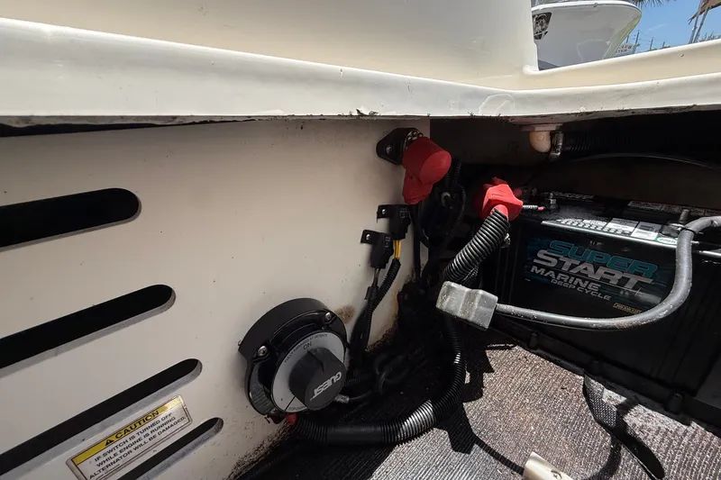 Slide: The Image of 2019 Sea Ray SPX 190 Outboard battery compartment with wiring and marine battery. - 41