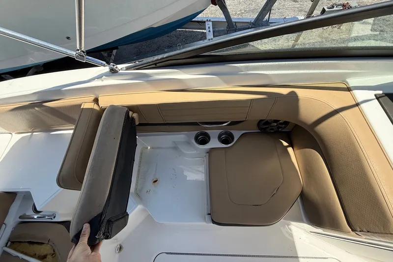 Slide: The Image of 2019 Sea Ray SPX 190 Outboard boat interior with tan seating and cup holders. - 25