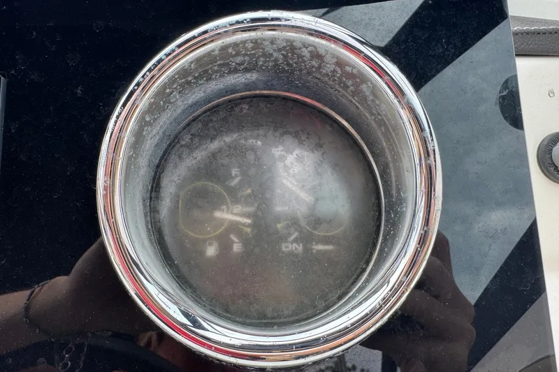 Slide: The Image of Close-up of a 2019 Sea Ray SPX 190 Outboard fuel gauge, showing reflections. - 10