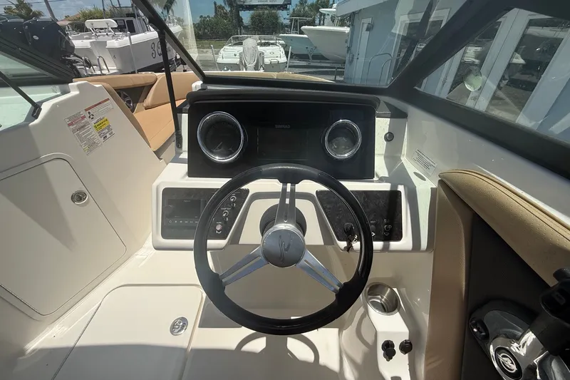 Slide: The Image of 2019 Sea Ray SPX 190 Outboard boat dashboard with steering wheel and controls. - 6