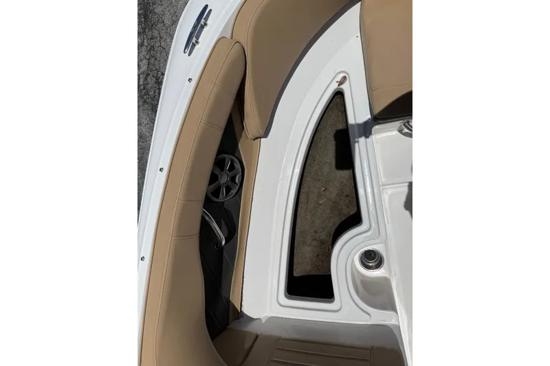 Slide: The Image of 2019 Sea Ray SPX 190 Outboard interior with tan seating and speaker detail. - 12