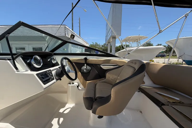 Slide: The Image of 2019 Sea Ray SPX 190 Outboard boat interior with steering wheel and dashboard. - 8
