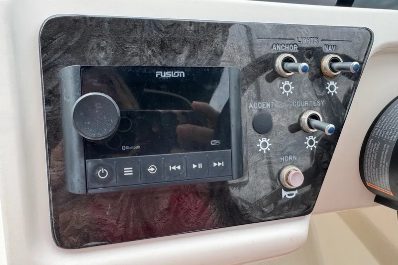 Slide: The Image of Control panel of a 2019 Sea Ray SPX 190 Outboard with Fusion audio system. - 11