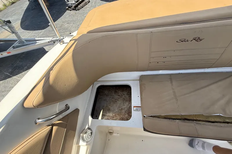 Slide: The Image of 2019 Sea Ray SPX 190 Outboard boat interior with tan seating and storage compartment. - 31