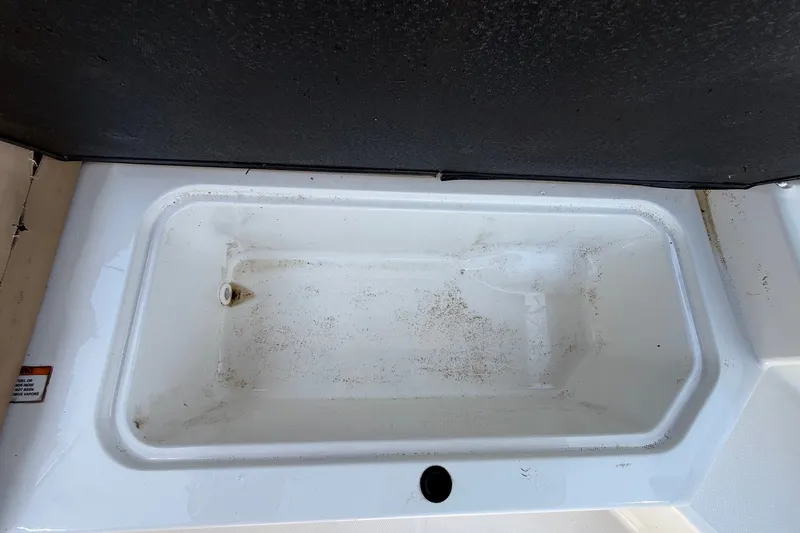 Slide: The Image of Storage compartment of a 2019 Sea Ray SPX 190 Outboard boat, showing interior details. - 30