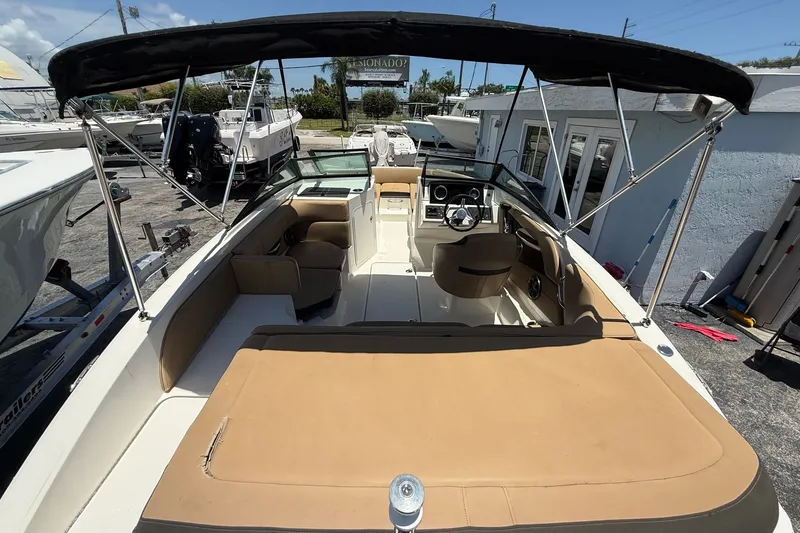 Slide: The Image of 2019 Sea Ray SPX 190 Outboard boat with tan seating and black canopy. - 4