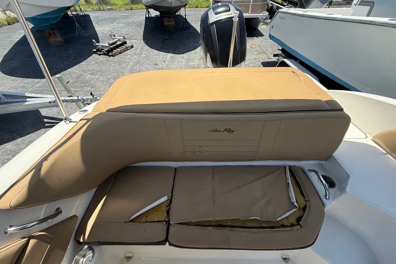 Slide: The Image of 2019 Sea Ray SPX 190 Outboard boat with tan upholstery, showing wear and tear. - 28