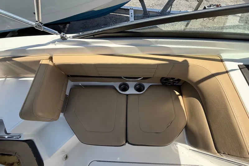 Slide: The Image of 2019 Sea Ray SPX 190 Outboard boat interior with tan seating and cup holders. - 26