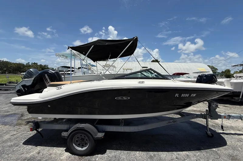 Slide: The Image of 2019 Sea Ray SPX 190 Outboard boat on trailer under clear blue sky. - 2