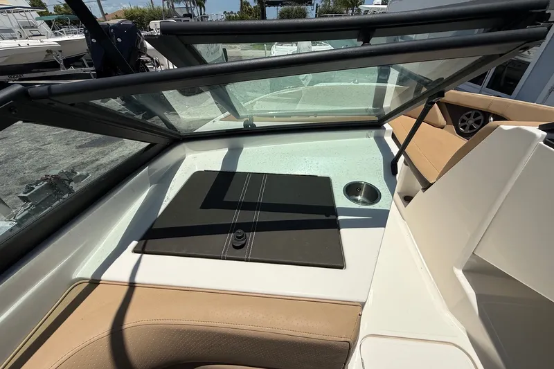 Slide: The Image of 2019 Sea Ray SPX 190 Outboard boat interior with tan seating and windshield. - 22