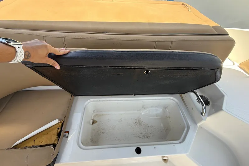 Slide: The Image of 2019 Sea Ray SPX 190 Outboard boat storage compartment with open seat cushion. - 29