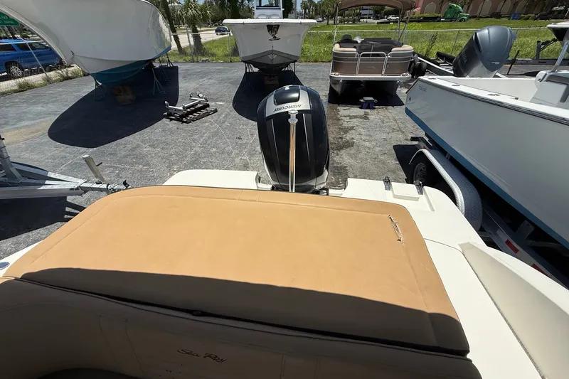 Slide: The Image of 2019 Sea Ray SPX 190 Outboard boat in a parking area with other boats. - 35