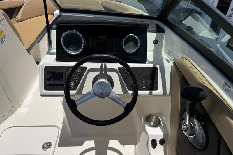 Slide: The Image of 2019 Sea Ray SPX 190 Outboard boat dashboard with steering wheel and control panel. - 7