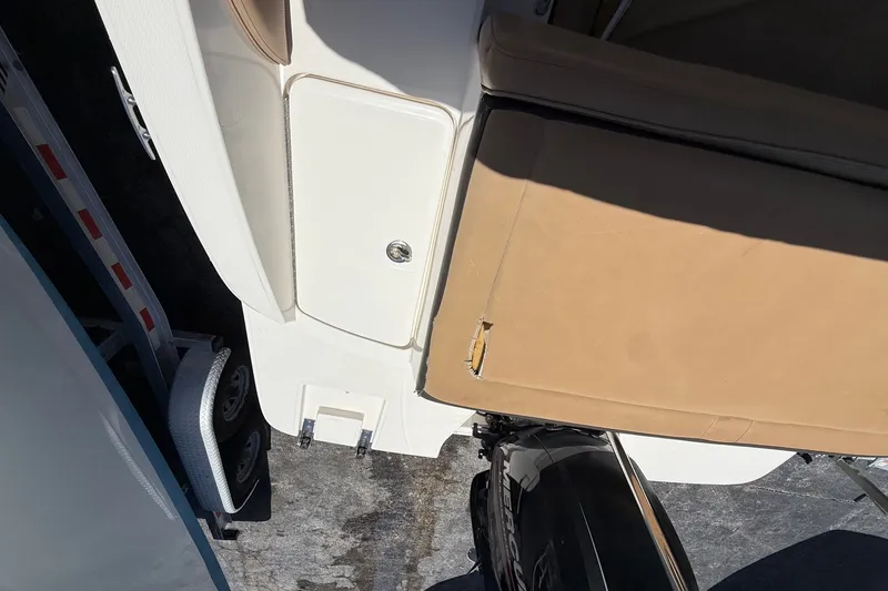 Slide: The Image of 2019 Sea Ray SPX 190 Outboard boat interior with tan seating and engine view. - 38