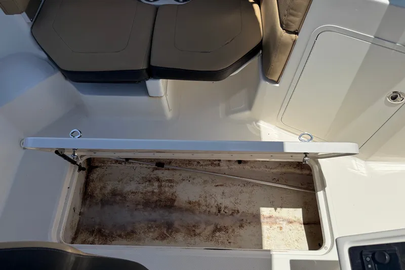 Slide: The Image of 2019 Sea Ray SPX 190 Outboard boat interior with open storage compartment. - 18