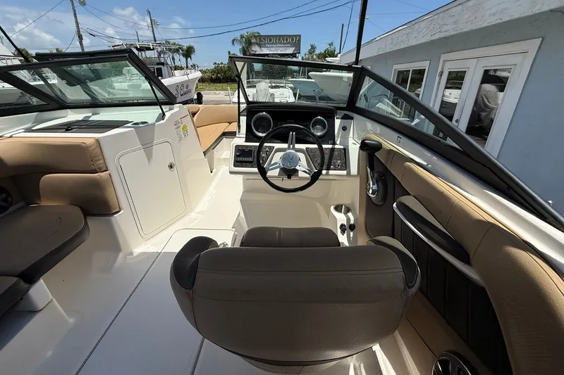 Slide: The Image of 2019 Sea Ray SPX 190 Outboard boat interior with steering wheel and seating. - 5