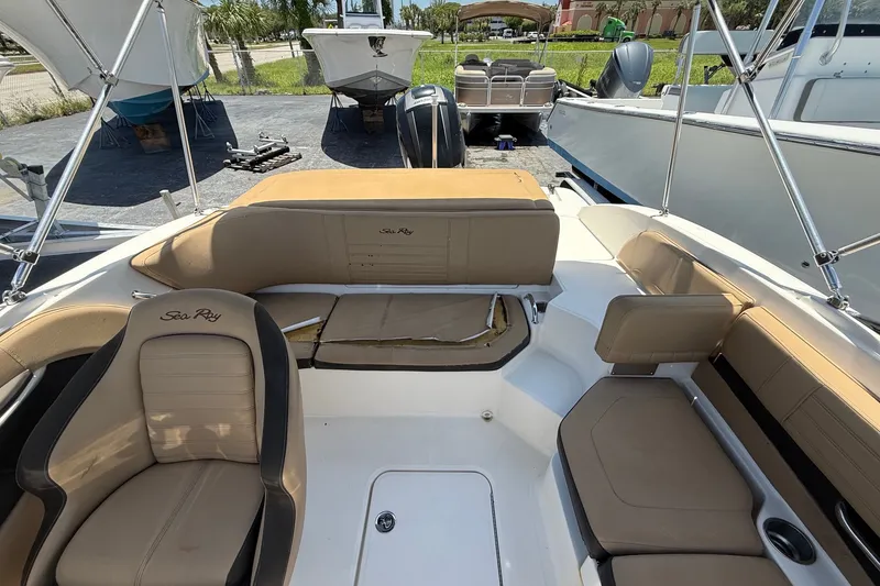 Slide: The Image of 2019 Sea Ray SPX 190 Outboard boat interior with tan seating and sleek design. - 27