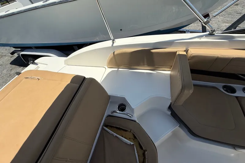 Slide: The Image of 2019 Sea Ray SPX 190 Outboard boat interior with tan seating and cup holders. - 34