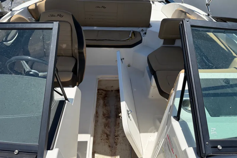 Slide: The Image of 2019 Sea Ray SPX 190 Outboard interior with seating and open storage compartment. - 17