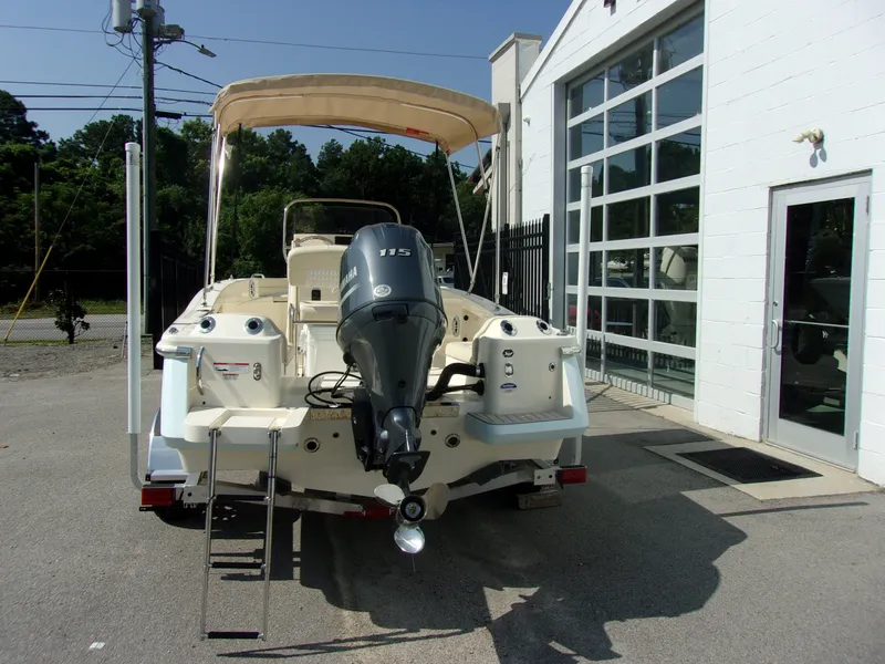 Slide: The Image of A 2026 Scout 188 Sportfish boat on a trailer in front of a building. - 4