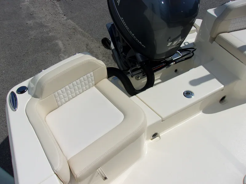 Slide: The Image of The image shows the seating area of a Scout 188 Sportfish boat with an outboard motor. - 8