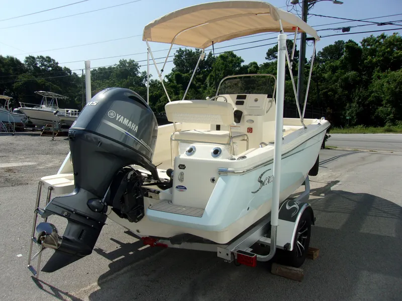 Slide: The Image of A 2026 Scout 188 Sportfish boat with a Yamaha outboard motor, parked on a trailer. - 5