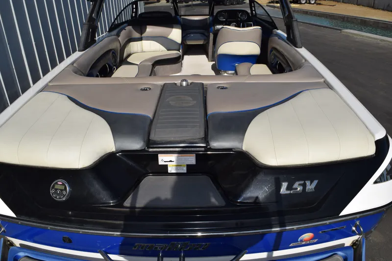 Slide: The Image of 2013 Malibu Wakesetter 23 LSV boat interior with beige and blue seating. - 4