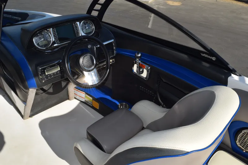 Slide: The Image of Interior of 2013 Malibu Wakesetter 23 LSV boat, featuring steering wheel and dashboard controls. - 10