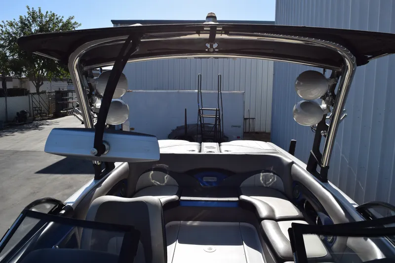 Slide: The Image of 2013 Malibu Wakesetter 23 LSV interior with tower speakers and seating. - 16