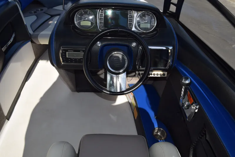 Slide: The Image of 2013 Malibu Wakesetter 23 LSV dashboard with steering wheel and control panel. - 11