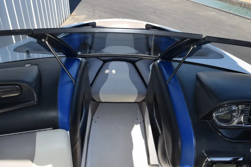 Slide: The Image of Interior view of 2013 Malibu Wakesetter 23 LSV boat, featuring sleek seating and dashboard. - 13