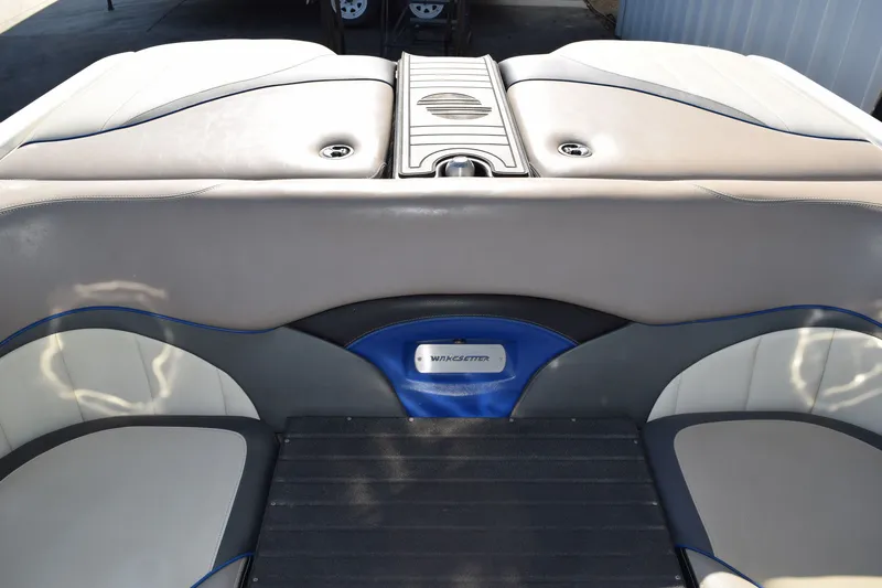 Slide: The Image of Interior seating of a 2013 Malibu Wakesetter 23 LSV boat, featuring gray and blue upholstery. - 17