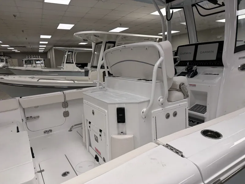 Slide: The Image of The image shows the cockpit of a 2027 Sea Hunt Ultra 265 SE boat in a showroom. - 3