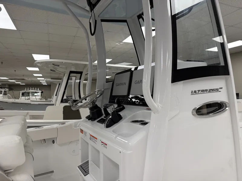 Slide: The Image of The image shows the cockpit of a 2027 Sea Hunt Ultra 265 SE boat with Garmin electronics. - 4
